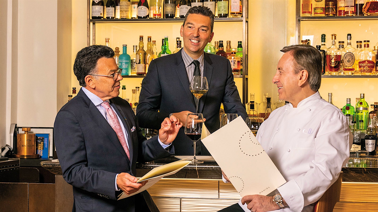 Daniel Johnnes and Sebastien Silvestri, of Dinex Group, at a bar with glasses of wine